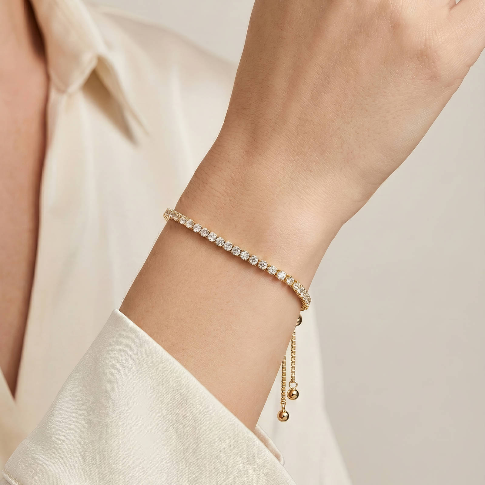Close-up of gold-plated tennis bracelet with cubic zirconia stones